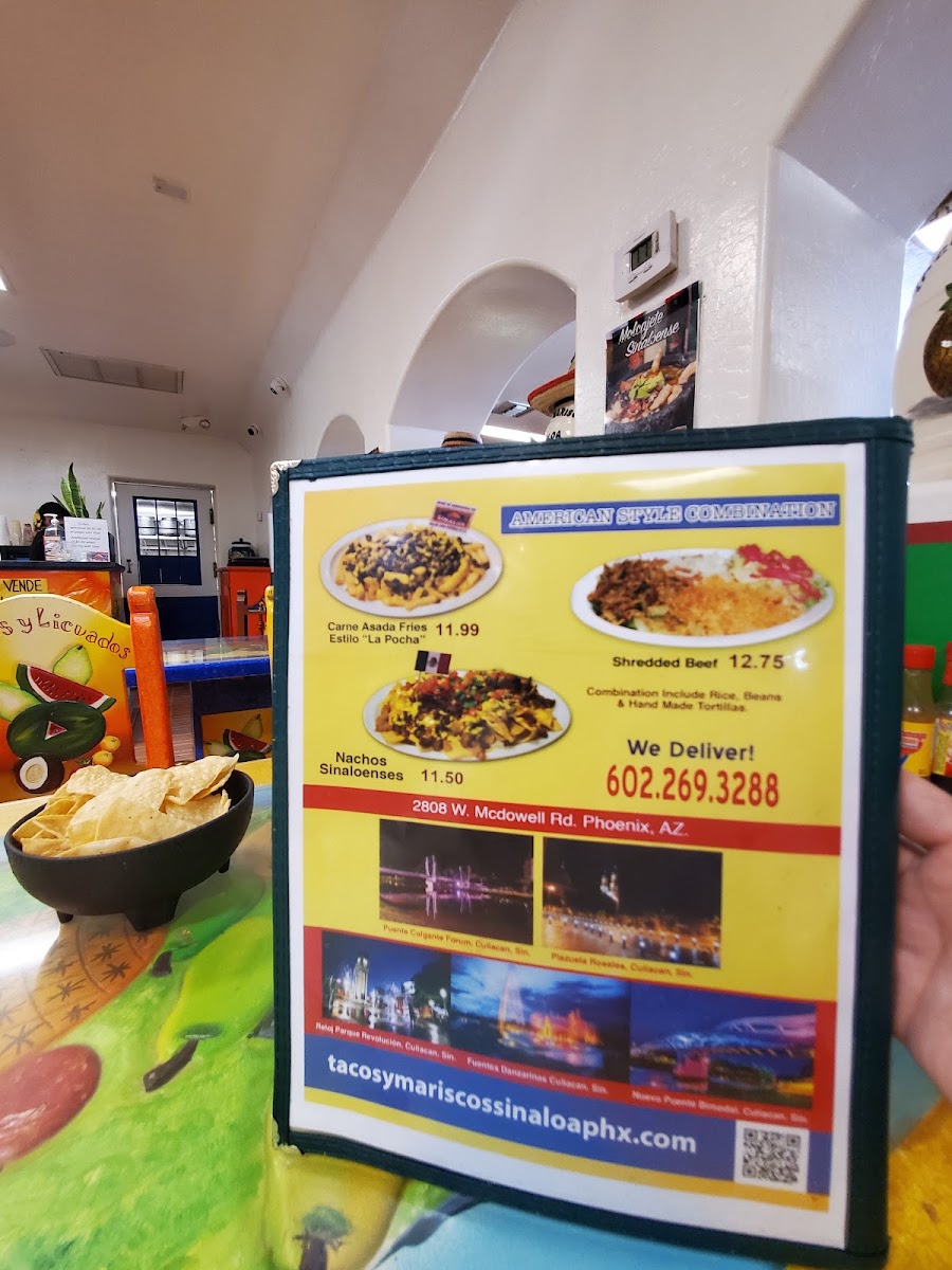 Tacos y Mariscos Sinaloa menu board