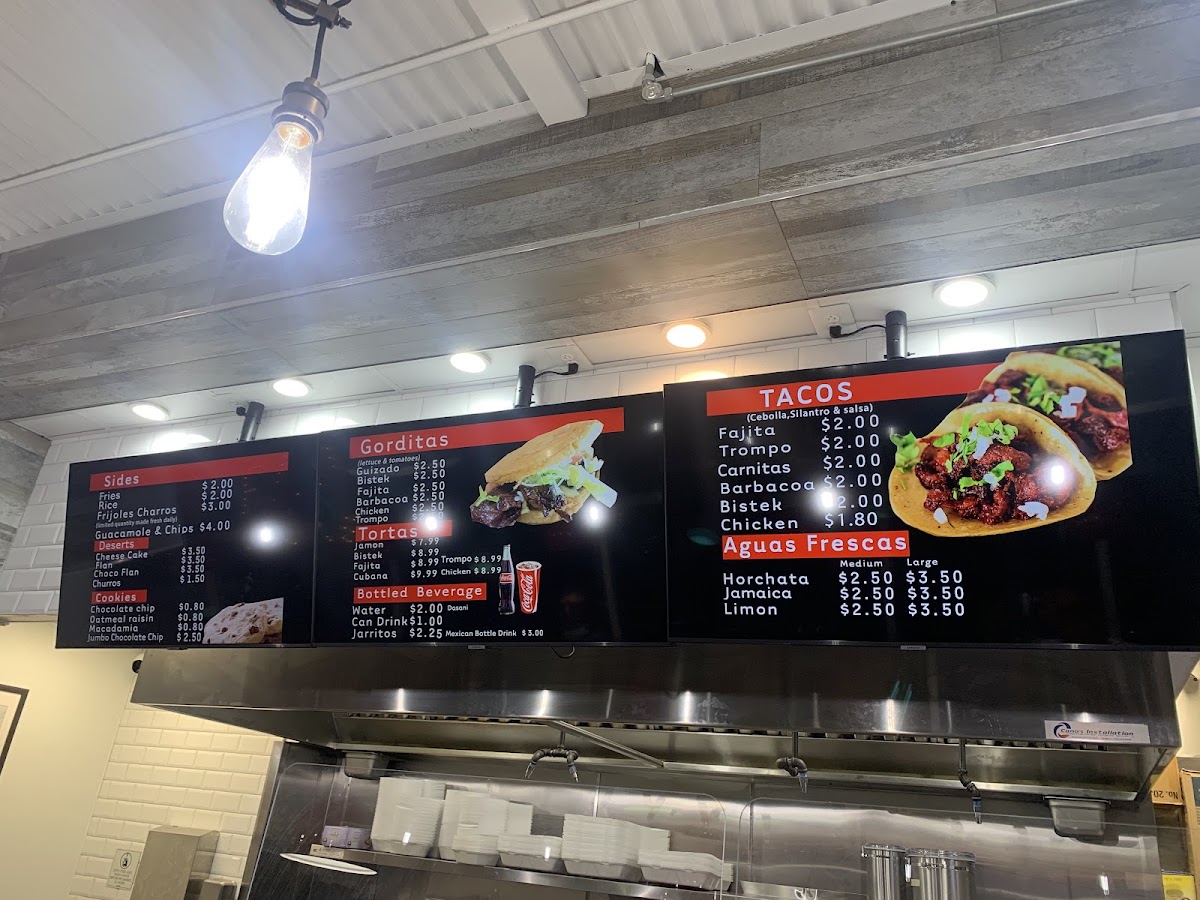 TACOS AL 100 menu board