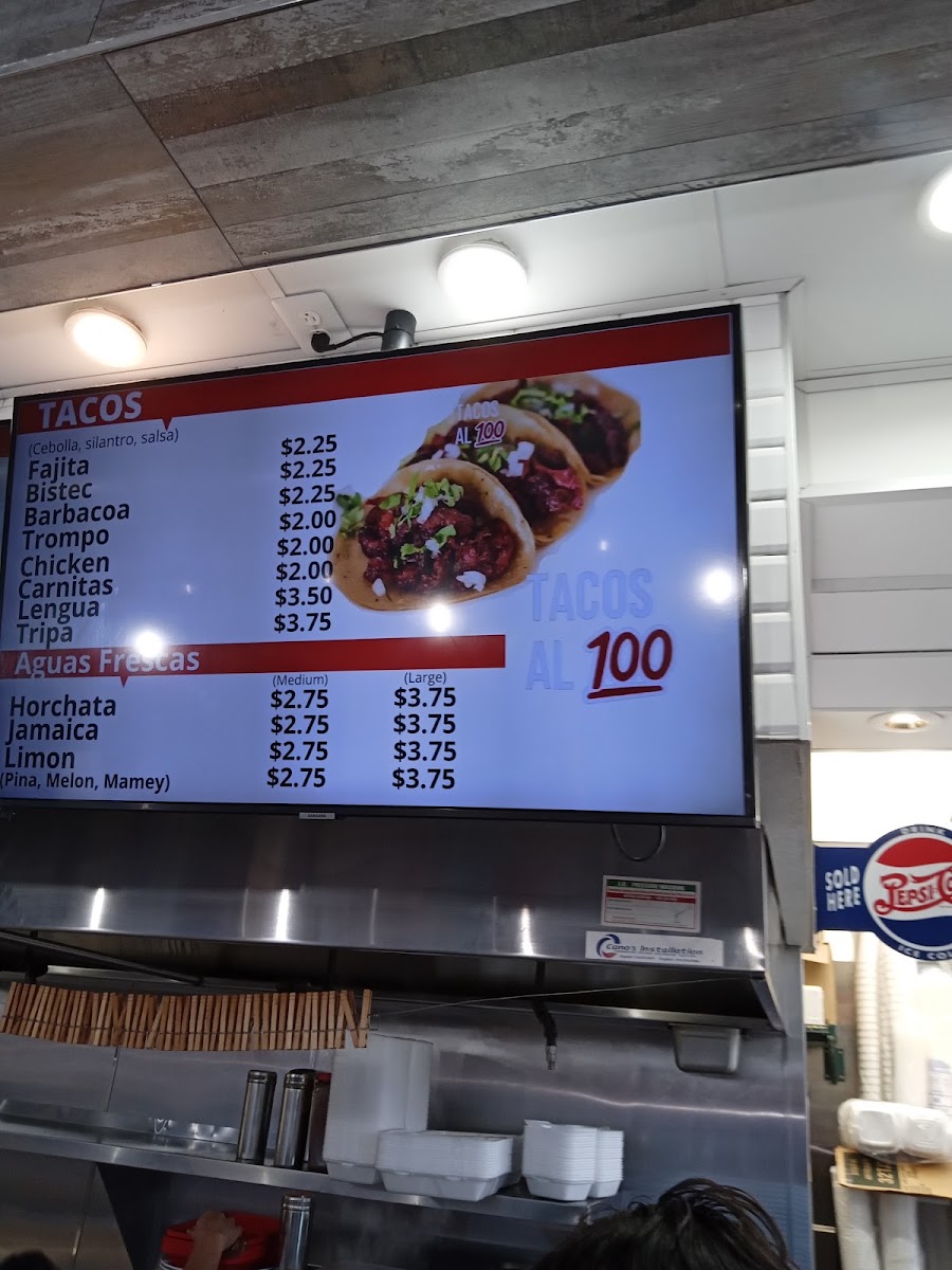 TACOS AL 100 menu board