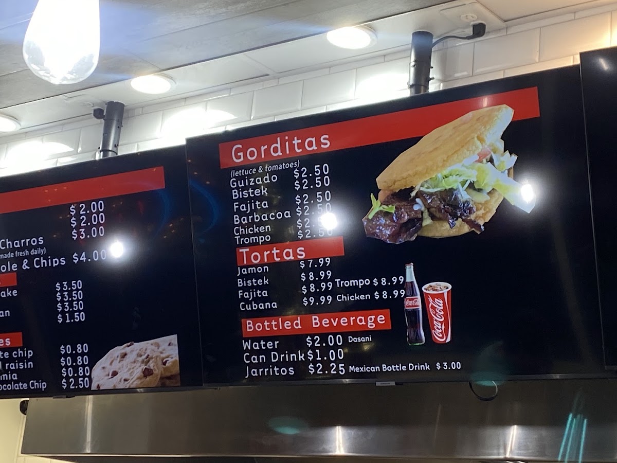 TACOS AL 100 menu board