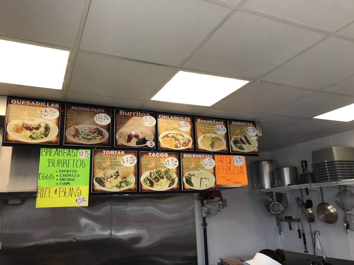 La Paisanita taqueria deli menu board