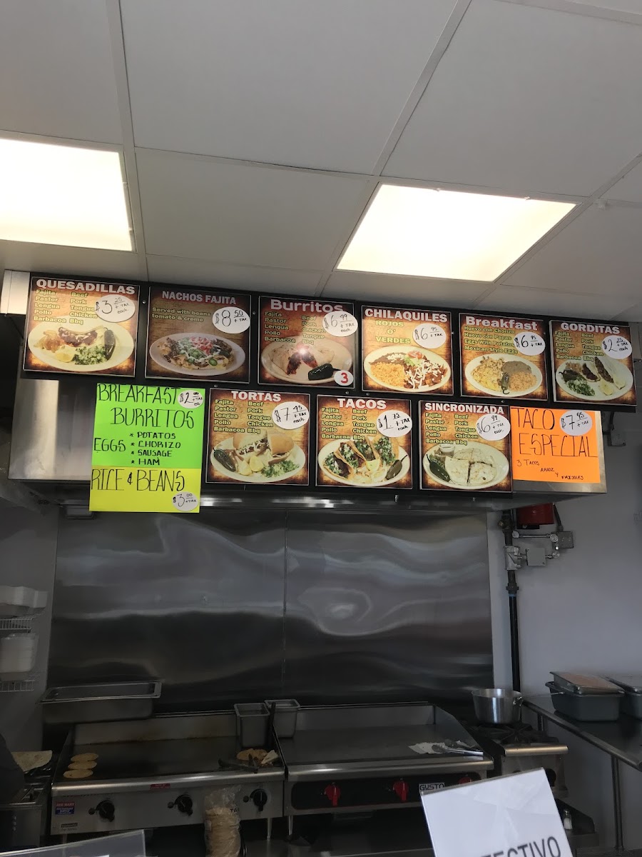 La Paisanita taqueria deli menu board