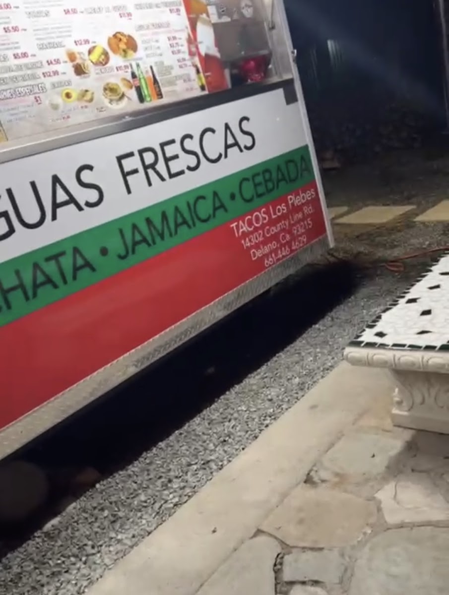 Tacos Los Plebes menu board