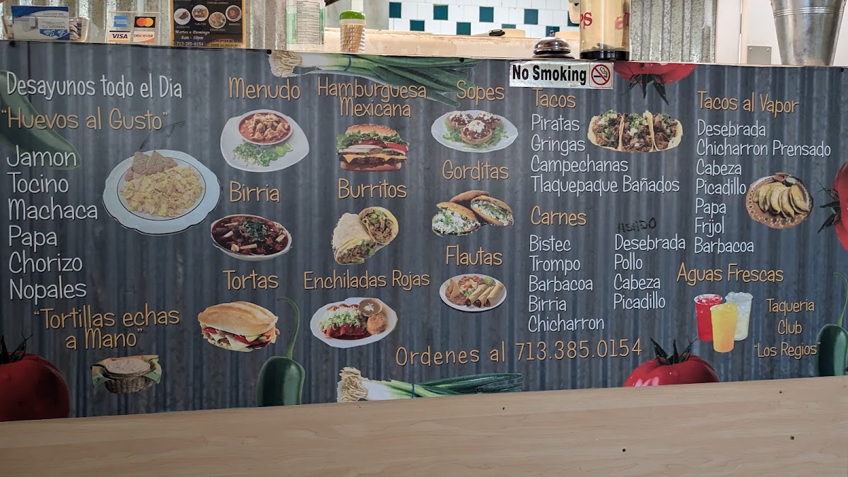 Taquería Club Los Regios menu board